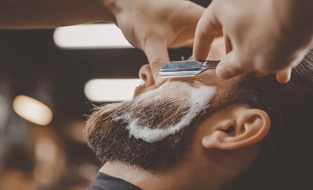 Barber shaving a customer