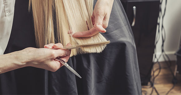 Hairdesser performing a hair cut